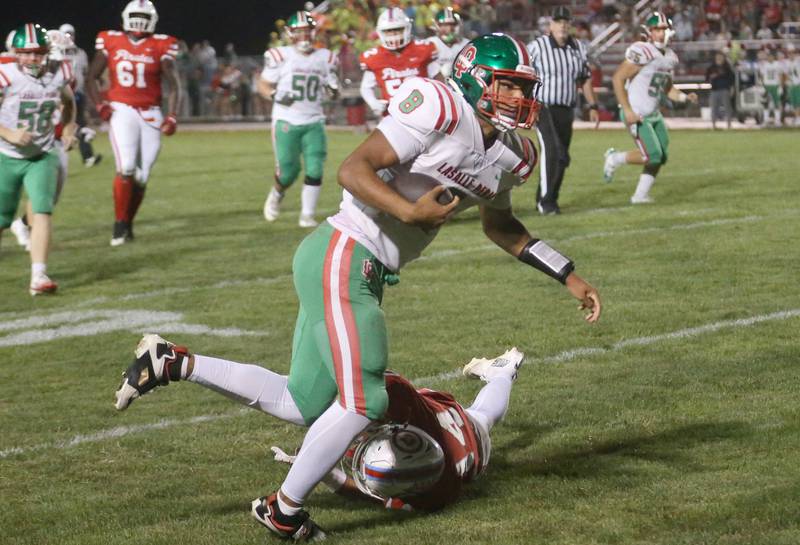 L-P quarterback Marion Persich breaks free of a tackle by Ottawa's Archer Cechowicz to score a touchdown Friday, Sept. 12, 2025, at King Field in Ottawa.