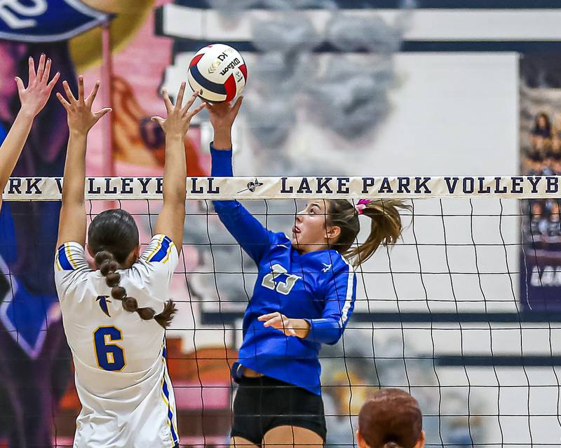 St. Charles North's Haley Burgdorf (23) tips the ball over the net during Class 4A Lake Park Regional final volleyball match between Wheaton North at St Charles North.  Oct 31, 2024  in Roselle.