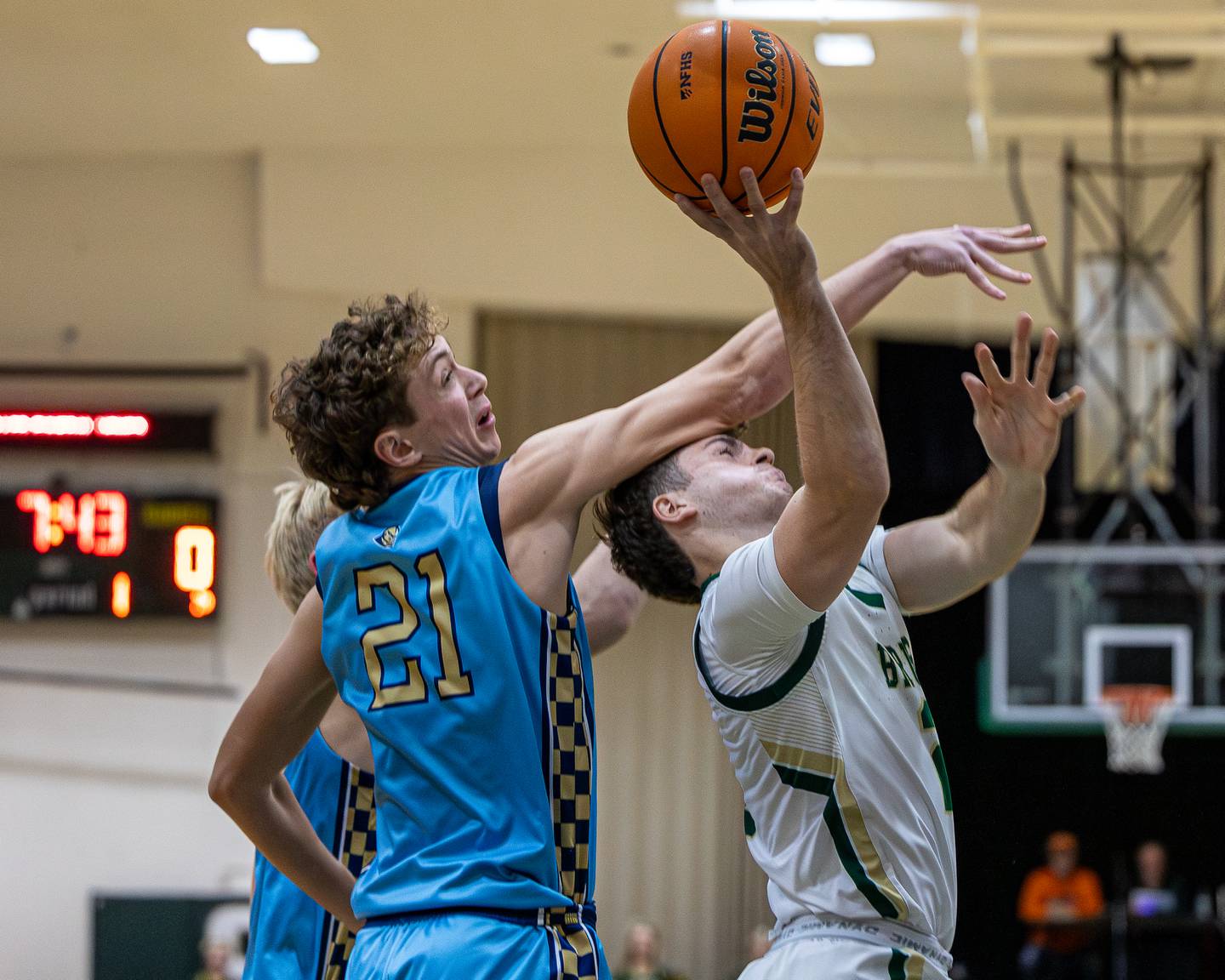 Gus Burr (2) of St. Bede lays up ball as Lucas Craig (21) of Marquette hits him on head in attempt to block shot on Friday, January 16, 2026 at St. Bede Academy in Peru.