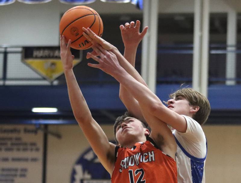 Woodstock’s Liam Laidig, right, battles Sandwich’s Braden Behringer for the ball in varsity boys basketball on Tuesday, Feb. 11, 2025, at  Woodstock High School in Woodstock.