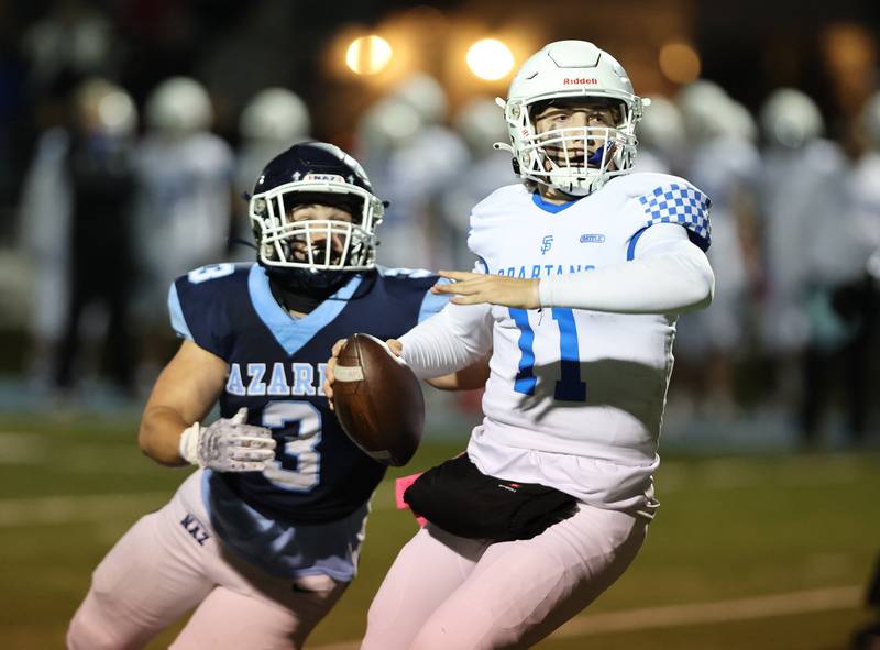 St. Francis’ Alessio Milivojevic (11) looks for a receiver against Nazareth during the boys varsity football game on Friday, Oct. 20, 2023 in La Grange Park, IL.