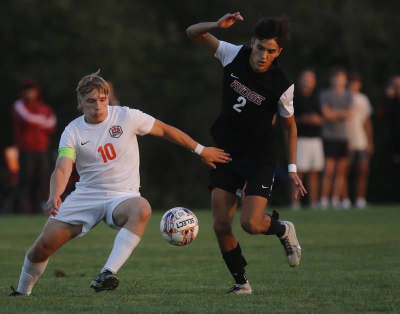 Crystal Lake Central's Gideon Burleson tries to beat Prairie Ridge's Logan Braun to the ball during a Fox Valley Conference soccer match on Thursday, Oct. 10, 2024, at Prairie Ridge High School.