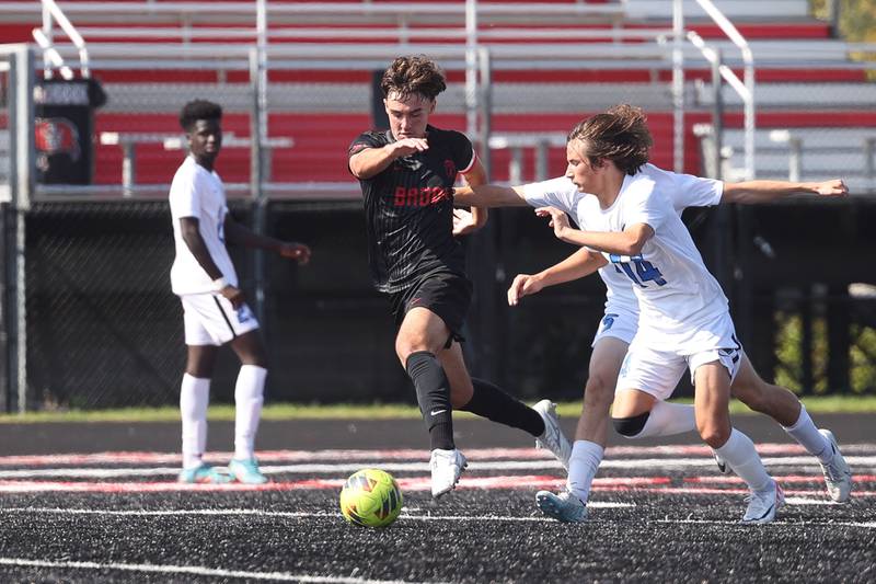 Bolingbrook’s Connor Capp get the ball away from Lincoln-Way East’s Owen Bohren on Saturday, Sept. 30, 2023 in Bolingbrook.