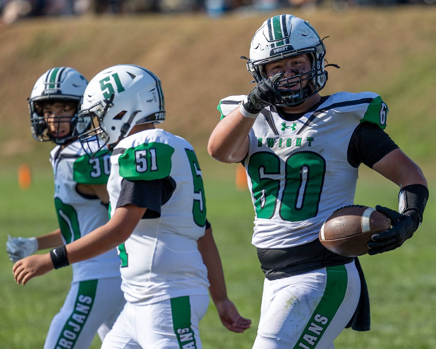 Ethan Holte (60) of Dwight points to scoreboard in excitement after big win against St. Bede on Saturday, Oct. 4, 2025 at Captain Thomas J. Heitmann field in Peru.