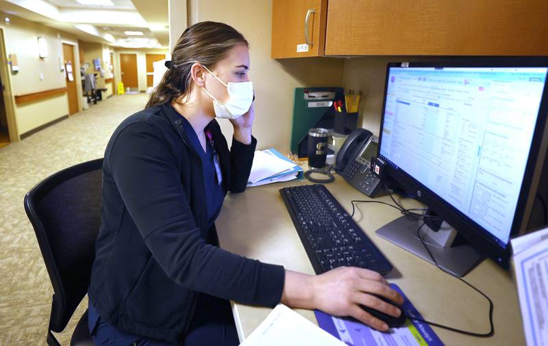 Travel nurse Taylor Zarris looks over some information on the computer Wednesday, March 23, 2022, at Northwestern Medicine Kishwaukee Hospital in DeKalb.