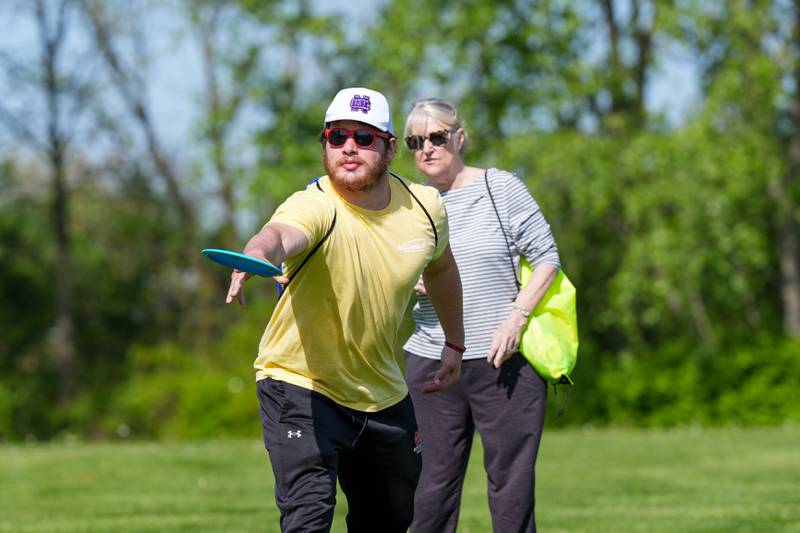 Park district staff show players how to throw a disc during the Glen Ellyn Park District Ace Race disc golf event at Maryknoll Park in Glen Ellyn, IL on Saturday May 10th, 2025.  The Ace Race is just one of many events the Glen Ellyn Park District holds throughout the year.