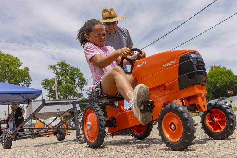 Amayah Comer pushes to gain every inch during the second round of the kiddie tractor pull Saturday, June 15, 2024, during Beef and Ag Days at Soldiers and Sailors Park in Princeton.