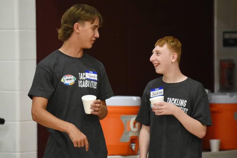 David Barwegen, left, and Jackson Dikte converse during a water break at Watseka's Tackling Disabilities football camp Saturday, July 26, 2025.