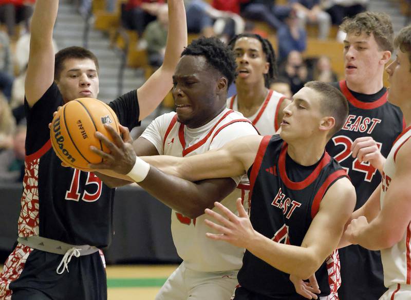 Palatine's Tony Balanganayi (50) is fouled by Glenbard East's Michael Nee (4) during the 51st Jack Tosh Holiday Classic basketball tournament Monday, Dec. 29, 2025 at York High School in Elmhurst.