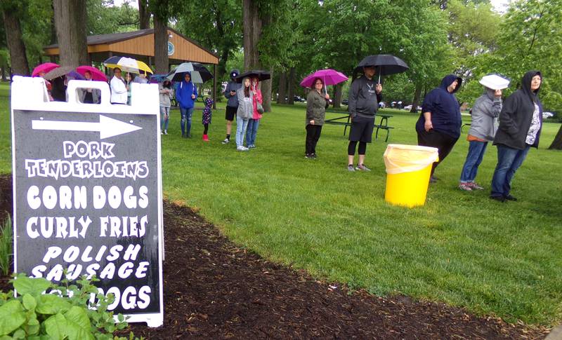 Streator Food Truck Festival goers wait in line for Cruisin' Concessions on Saturday, May 21, 2022, at City Park.