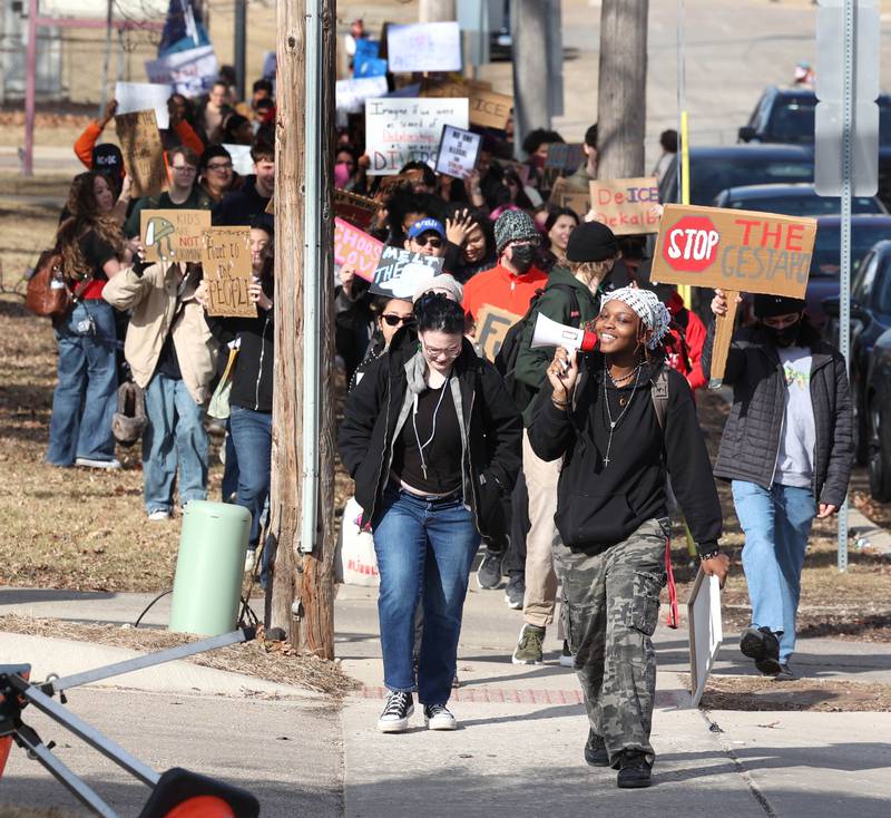 Northern Illinois University students march up Carroll Avenue Friday, Feb 13, 2026, on their way to the DeKalb Police Department on Lincoln Highway to protest against recent U.S. Immigration and Customs Enforcement activity.