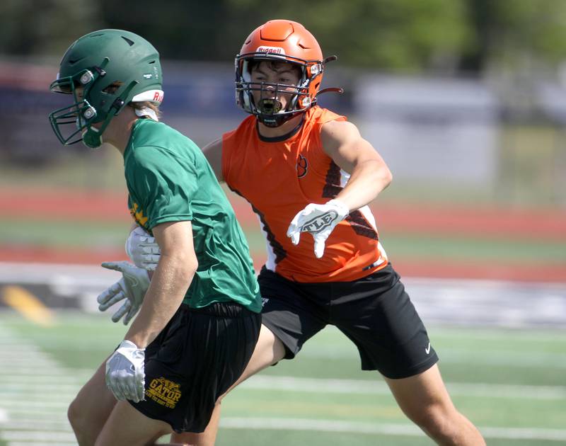 Wheaton Warrenville South’s Charlie Butt breaks up a pass during a 7 on 7 tournament at St. Charles North High School on Thursday, June 30, 2022.