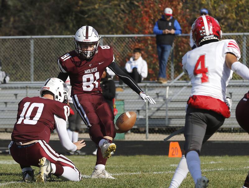 Prairie Ridge’s Lanndon kicks an extra point out of the hold of quarterback, Owen Satterlee,during an IHSA Class 5A first-round football game on Saturday, Nov. 2, 2024, at Prairie Ridge High School in Crystal Lake.