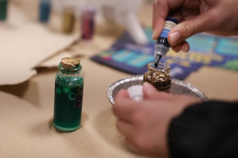 Kids make potions at the STEAM Spooktacular hosted by the After the Peanut Foundation on Wednesday at Lewis University.