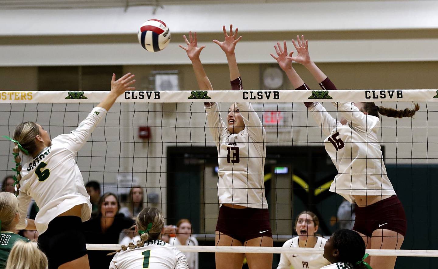 Crystal Lake South's Bobbi Wire tries to hit the ball through the block of Prairie Ridge's Abigail Smith (center) and Adeline Grider during the IHSA Class 3A Crystal Lake South Sectional final volleyball match on Thursday, Nov. 7, 2024, at Crystal Lake South High School.