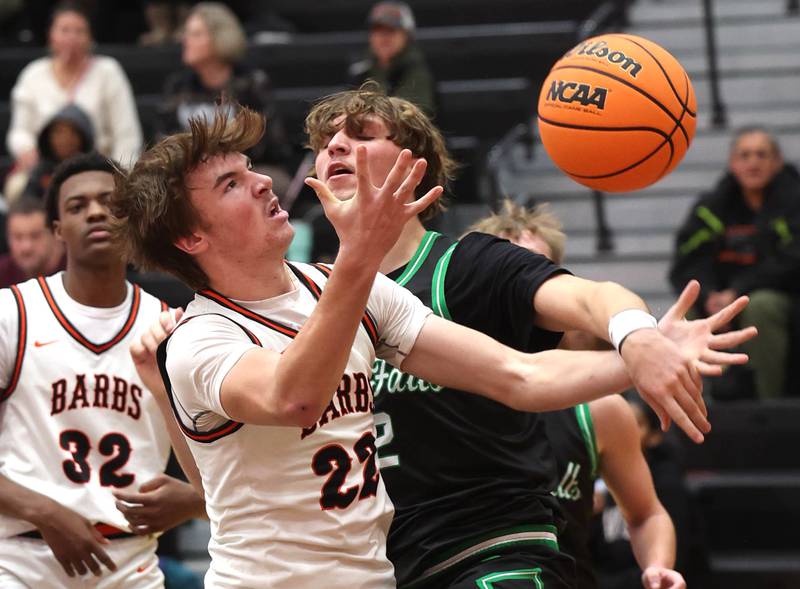 DeKalb's William Smrz (left) and Rock Falls' Cole Mulnix go after a rebound during their game Tuesday, Dec. 2, 2025, at DeKalb High School.