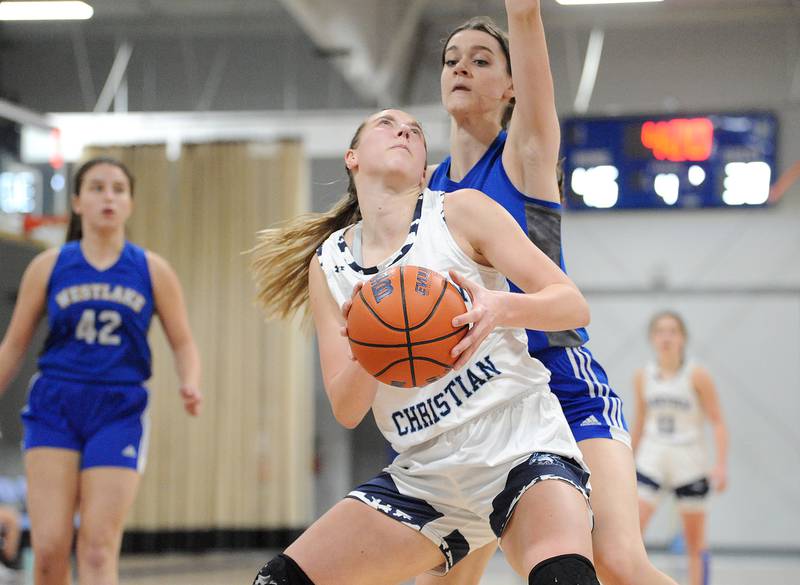 Parkview Christian's Elizabeth Griswold looks for a shot under the basket against Westlake Christian defender Lucy Hudson during a girls' basketball game at Parkview Christian Academy on Tuesday, Dec. 20, 2022.