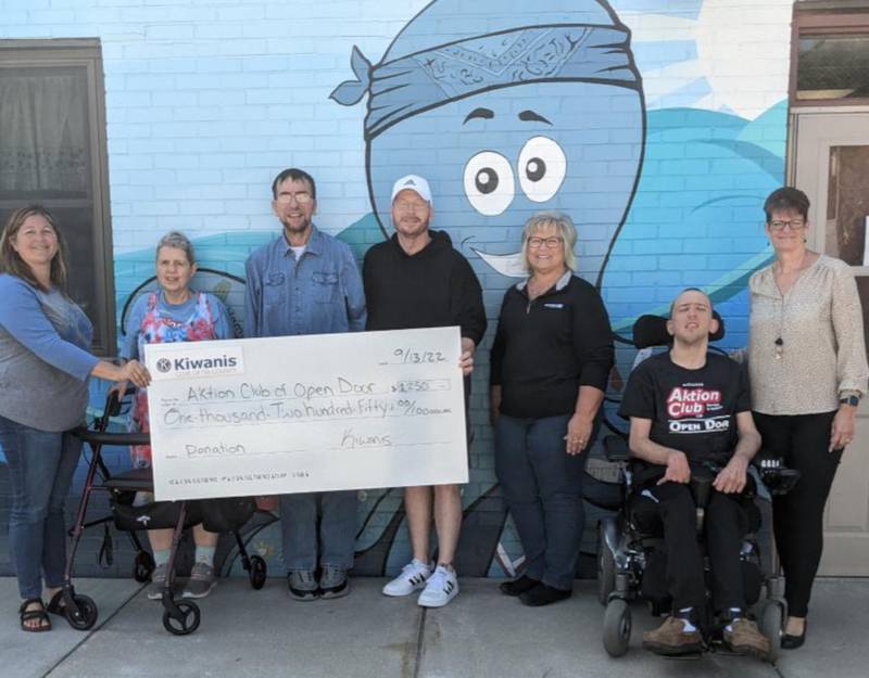 Tri-County Kiwanis members present a donation to members of the Open Door Aktion Club.