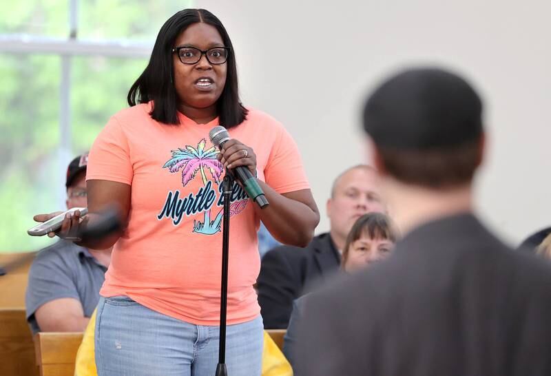 Latasha Williams, from DeKalb, asks a question of Clint-Michael Reneau, vice president for student affairs at Northern Illinois University, after he spoke about the proposed NIU Center for Greek Life during the informational meeting Thursday, May 18, 2023, at New Hope Missionary Baptist Church in DeKalb. The meeting centered on the the proposed plans for the vacant lot on the corner of Blackhawk Road and Hillcrest Drive in DeKalb.