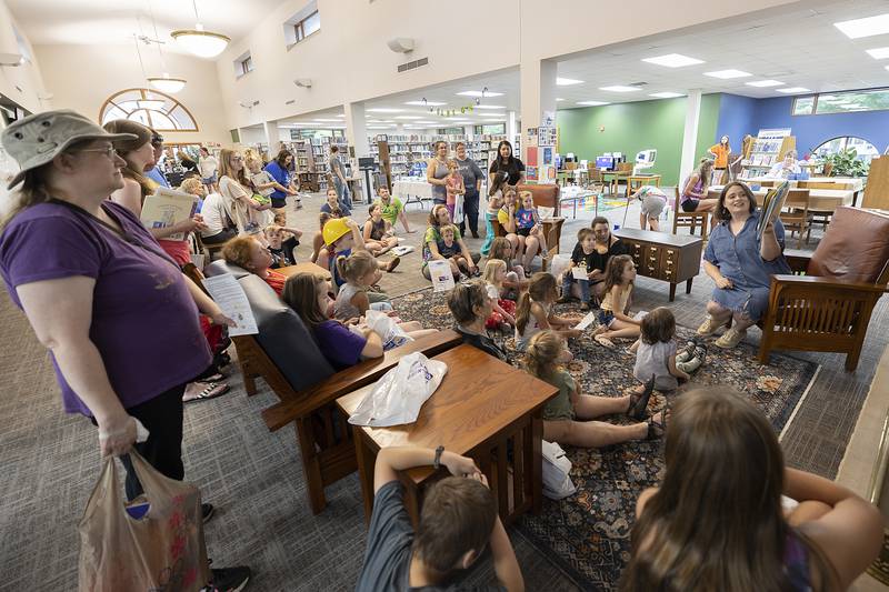 Visitors listen to a reading of “Dandelion Magic” Wednesday, June 25, 2025, at the Odell Library in Morrison.