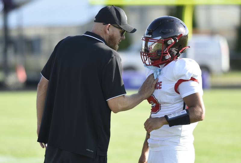 Momence's Erick Castillo, right, talks with a coach during a scrimmage game against Manteno on Friday, August 22, 2025.