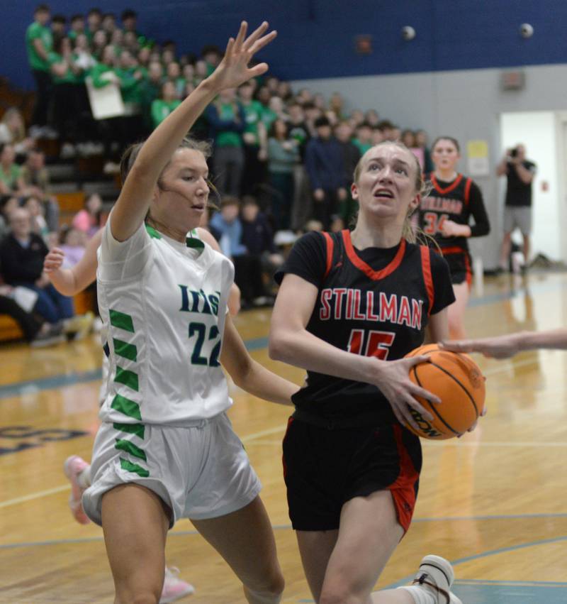Stillman Valley's Taylor Davidson (15) drives to the basket as Peoria Notre Dame's Amy Wardle (22) defends during the 2A Super-Sectional on Monday, March 3, 2025 at Bureau Valley High School in Manlius.