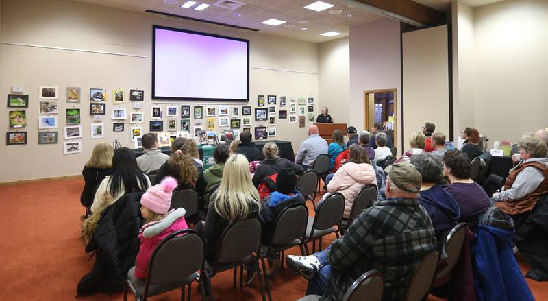 Lisa Sons Natural Resource Coordinator, speaks to a room full of spectators during the Starved Rock Photography Show awards on Saturday, Jan. 4, 2024 at the Starved Rock Visitors Center.