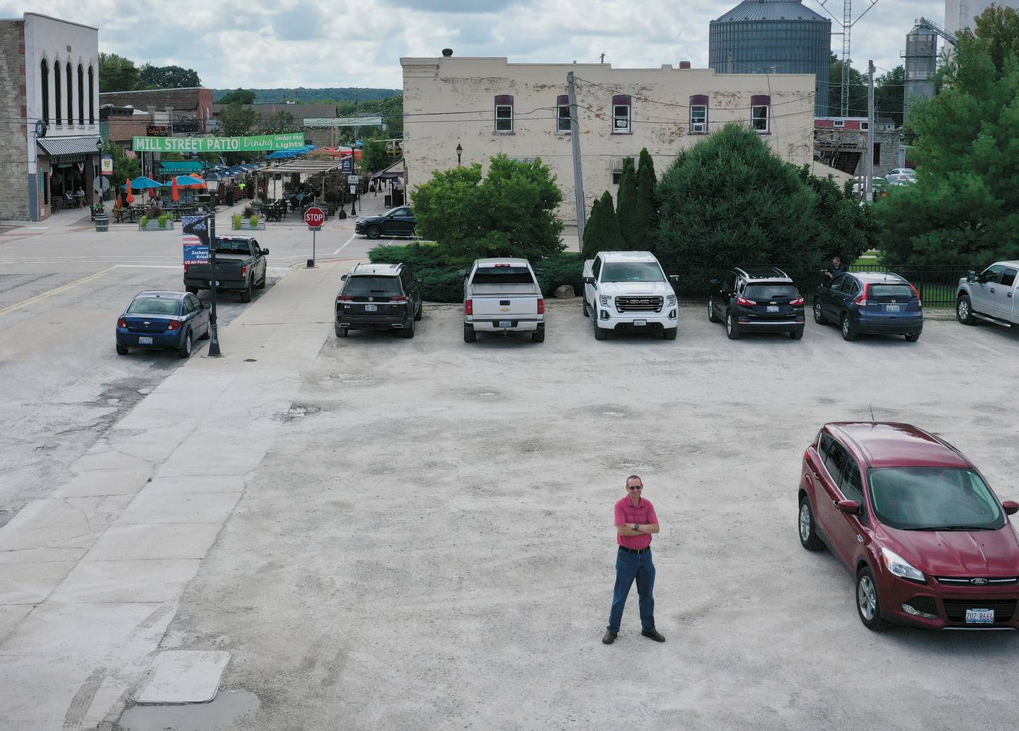 Utica mayor Dave Stewart poses for a photo behind the tornado memorial on Friday, Aug. 26, 2022 in Utica. Where Stewart is standing, will be a dozen huts that will occupy the space. The gravel lot will also be paved.