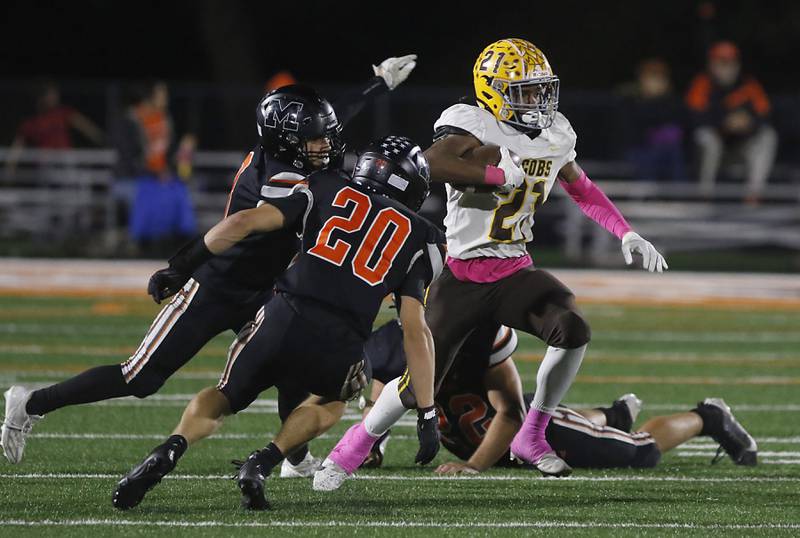 Jacobs' Michael Cannady cuts back as he runs against McHenry's Braydon Stebbins during a Fox Valley Conference football game on Friday, Oct. 18, 2024, at McCracken Field in McHenry.