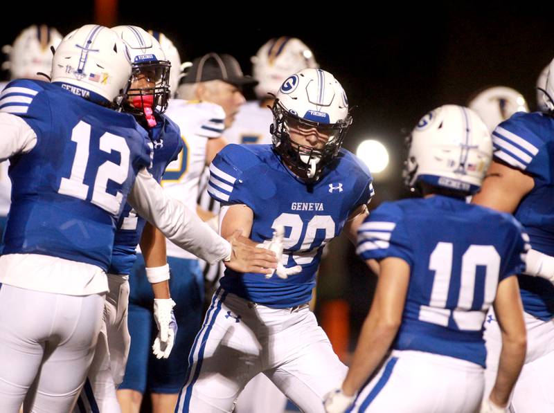 Geneva’s Michael Rumoro is congratulated after a touchdown score during a game against Wheaton North on Friday, Oct. 11, 2024 at Geneva.