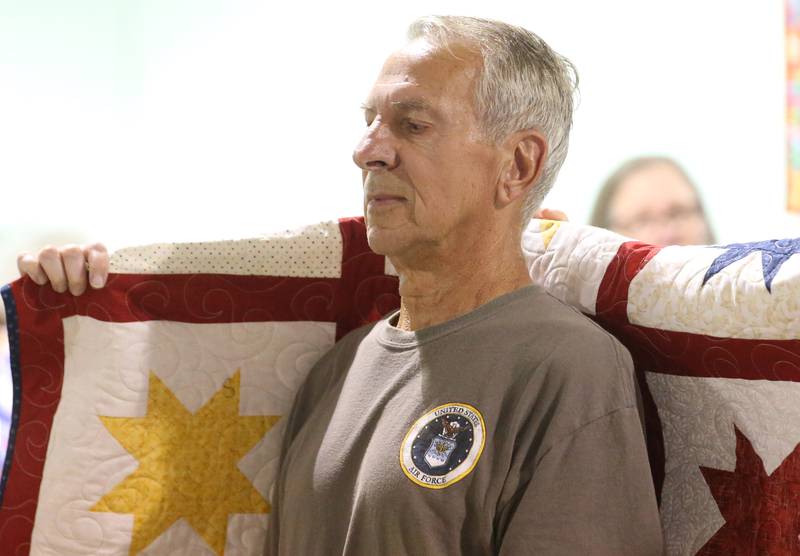 U.S. Air Force Veteran Larry Dzierzynski of Peru, receives his Quilt of Valor during the Tribute to Veterans on Wednesday, Aug. 20, 2025 at the Bureau County Fair in Princeton.