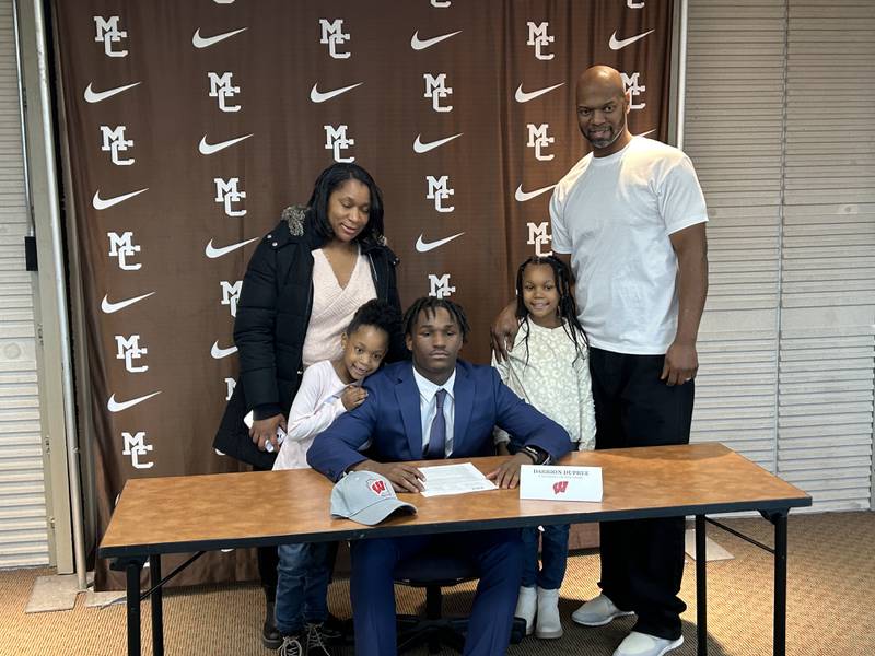 Mount Carmel running back Darrion Dupree poses with his family during a signing day ceremony in the Chicago school Wednesday.