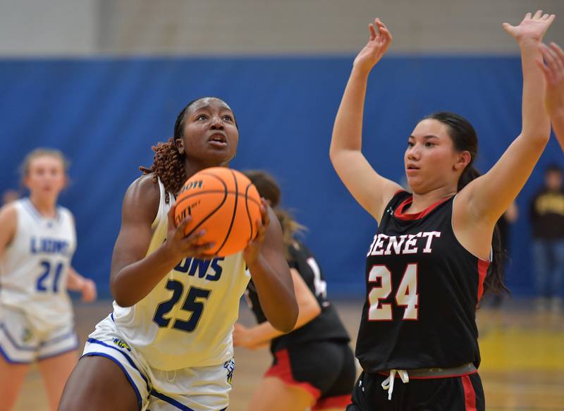 Lyons Township's Nora Ezike (25) goes to the basket as Benet's Emma Briggs (24) defends during a game on November 19, 2024 at Lyons Township High School in LaGrange.