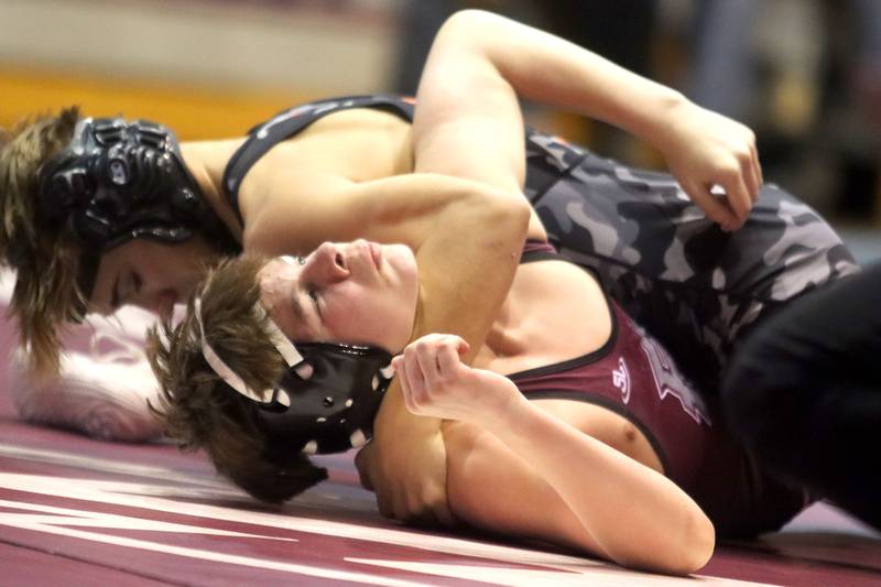 McHenry’s Tyson Rivard, top, battles Prairie Ridge’s Connor Pease at 113 pounds in varsity boys wrestling on Thursday, Jan. 8, 2026 at Prairie Ridge High School in Crystal Lake.