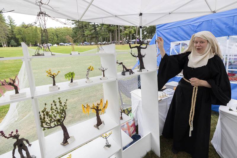 Marlo Glass of Macomb discusses her miniature sculptures on display Saturday, Sept. 21, 2024, at Fall and Fantasy Fest. The works are hand made and decorated with influences of many tress including birch, willow and oak.