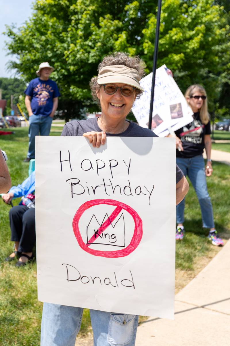 Protester holds sign at the “No Kings” protest on Saturday, June 14, 2025 at Rotary Park in Princeton.