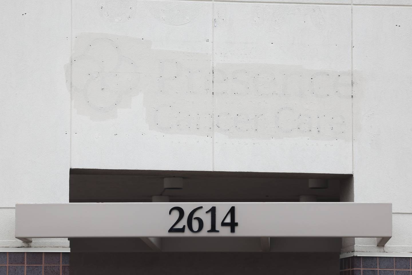 The old Presence Cancer Care sign is visible due to weathering after being taken down at the Duly Joliet Oncology-Hematology Center building along Jefferson Street in Joliet.