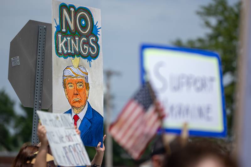 Sign that reads “No Kings” is held on Saturday, June 14, 2025 at Rotary Park in Princeton.