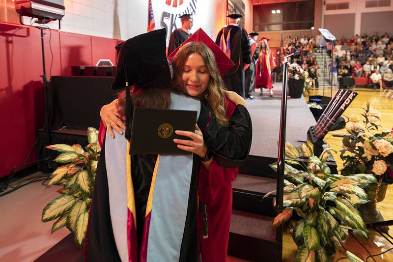 Student speaker Madison Krum hugs Dr. Lori Cortez after receiving her diploma Friday, May 15, 2026, during Sauk Valley Community College's commencement ceremony.