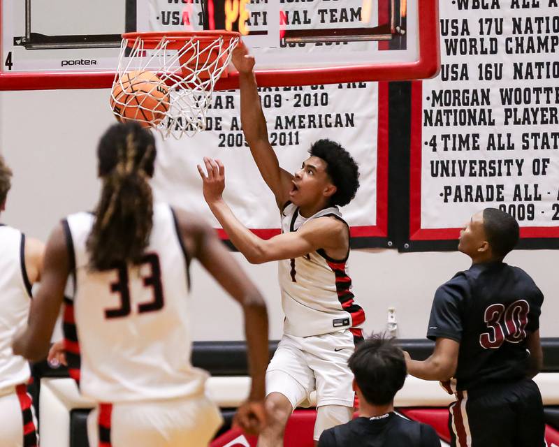 Bolingbrook's Braden Pettigrew (1) dunks during their basketball game between Plainfield North at Bolingbrook, Friday Dec 13, 2024 in Bolingbrook.