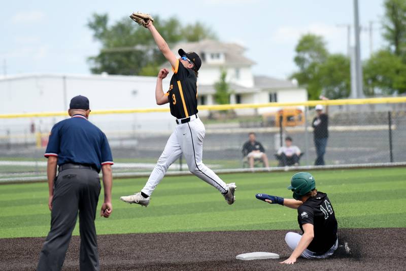 Herscher's Alec Nicholos (3) leaps to field a throw at second base as Bishop McNamara's Callaghan O'Connor slides in during the Class 2A Herscher Regional championship Saturday, May 24, 2025.