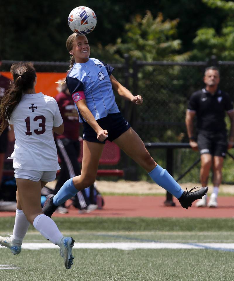 Nazareth Academy's Sarah Owen heads the ball away from St. Ignatius College Prep's Lili Garcia during a IHSA Class 2A State Girls Soccer semifinal match on Friday, June 6, 2025, at North Central College in Naperville.