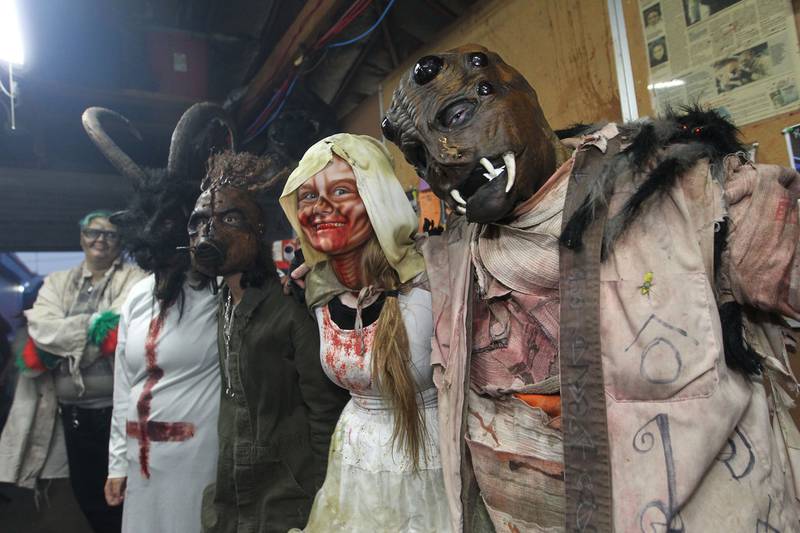 A group of performers show off their costumes before scaring visitors at the Realm of Terror Haunted House in Round Lake Beach