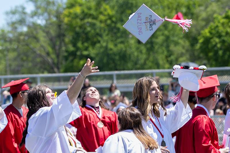 Graduates throw caps into air on Sunday, May 18, 2025 at Hall High School in Spring Valley.