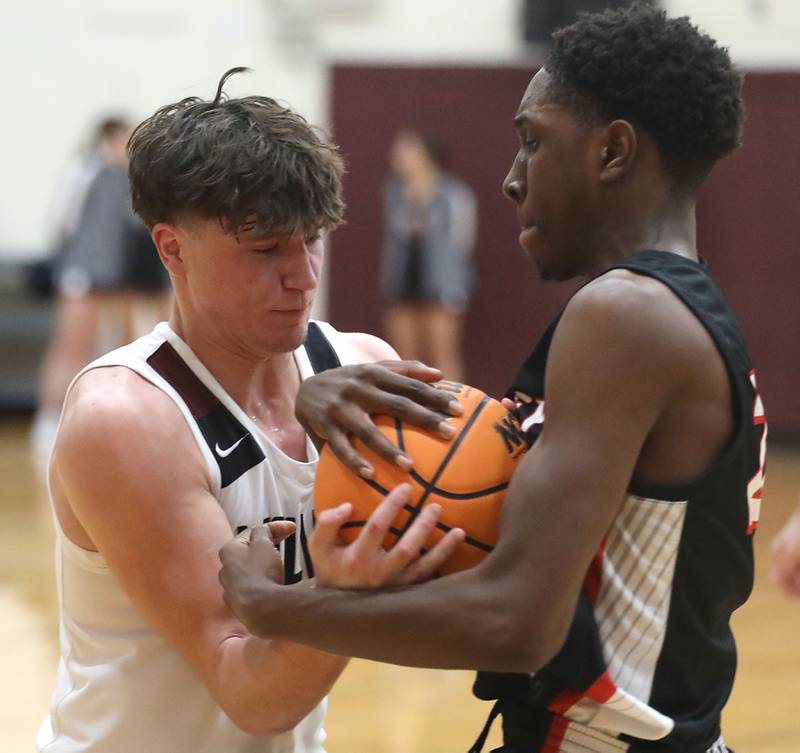 Prairie Ridge's Elijah Loeding battles with Huntley's Isaiah Onu for possession of the ball during a Fox Valley Conference boys basketball game on Wednesday, Jan. 21, 2026, at Prairie Ridge High School in Crystal Lake.
