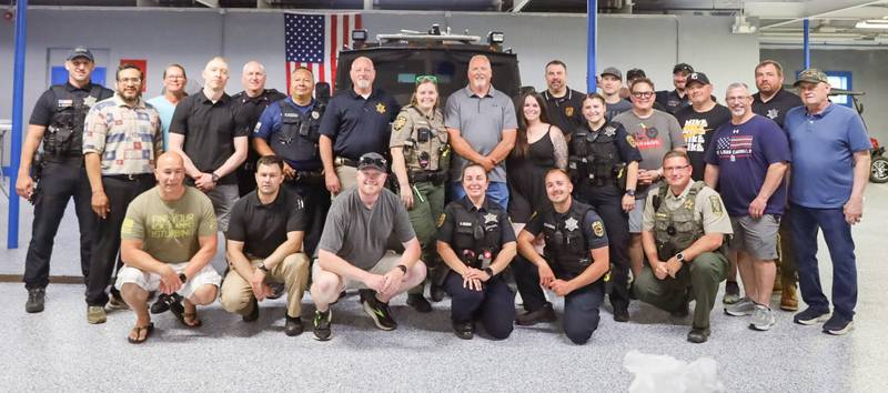 Erik Sorenson, who is retiring after 27 years with the Princeton Police Department, is greeted by a host of law enforcement officers, during his retirement open house at the PPD on Tuesday. Sorenson served 30 years in all in law enforcement, including three with the Bureau County Sheriff's Office.