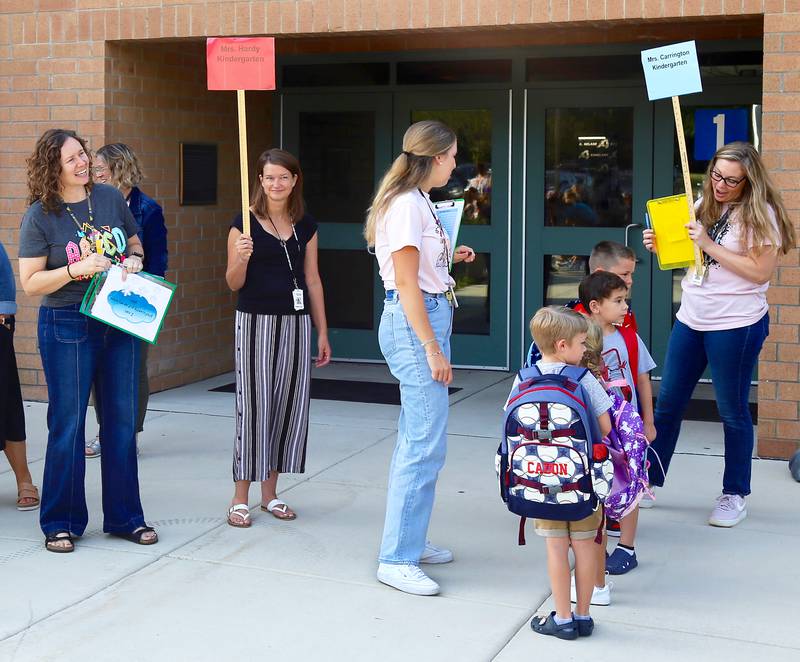 Kindergarten teachers greet students at Kaneland John Stewart Elementary in Elburn on Wednesday, Aug. 14, 2024.