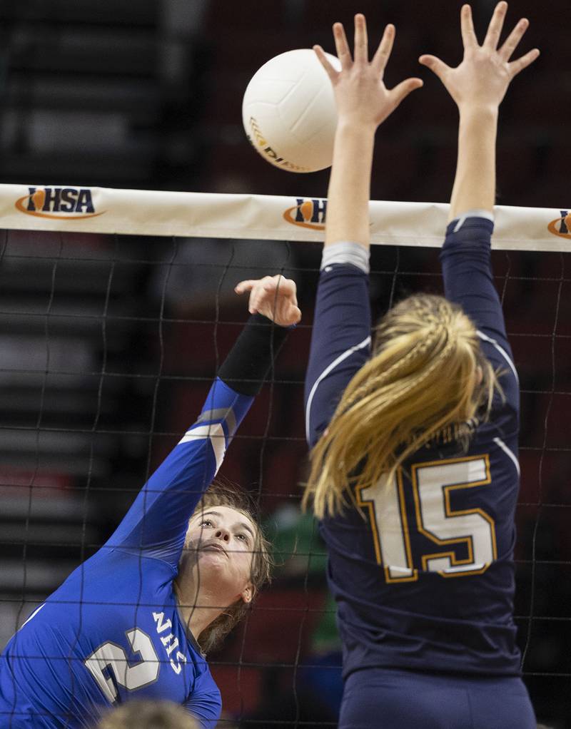 Newman’s Sophia Ely hammers a ball Friday, Nov. 11, 2022 in a class 1A volleyball semifinal against Aquin’s Megan Holder..