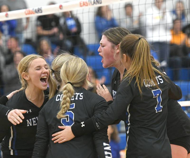 Newman players react after winning a point en route to their win at the Eastland Supersectional in Lanark on Friday, Nov.4. Newman won the match to advance to the state finals next week.