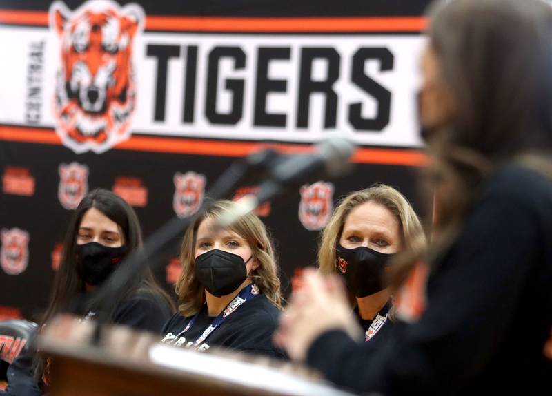 From left, Assistant Coach Alexa Kritikos, Head Coach Elizabeth Lamb and Vice Principal Kim Bromley listen to team member Kali Augoustatos speak on Sunday. Crystal Lake Central held a celebration in their gymnasium after the Tigers on Saturday won the IHSA state title in Competitive Cheerleading-Medium Team at Grossinger Motors Arena in Bloomington.
